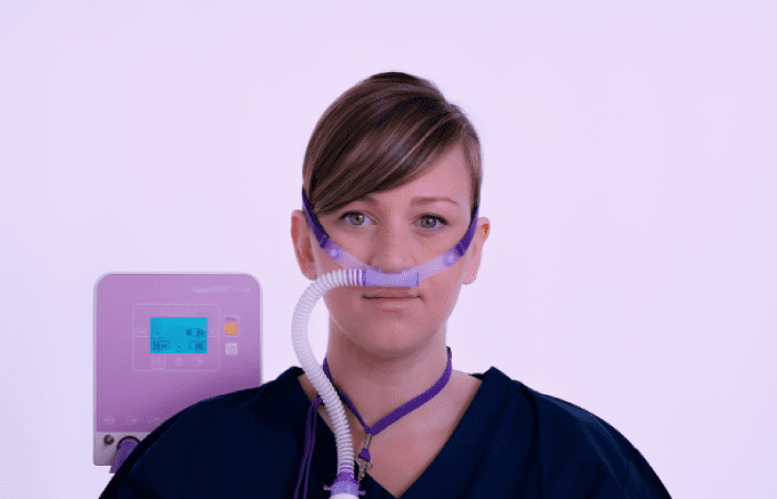 A woman with a nasal canula connected to the FD140 by Armstrong Medical